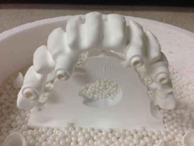 CAD/CAM zirconium frames, embedded in pearl powder before sintering-3